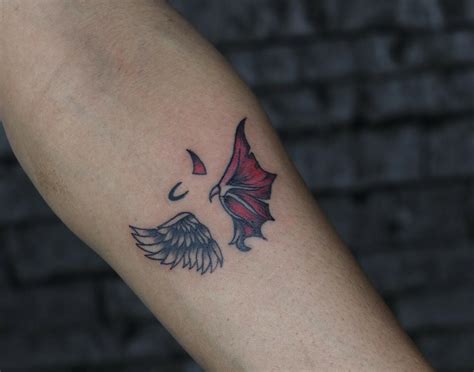 angel with devil tattoo|angel stepping on demon tattoo.